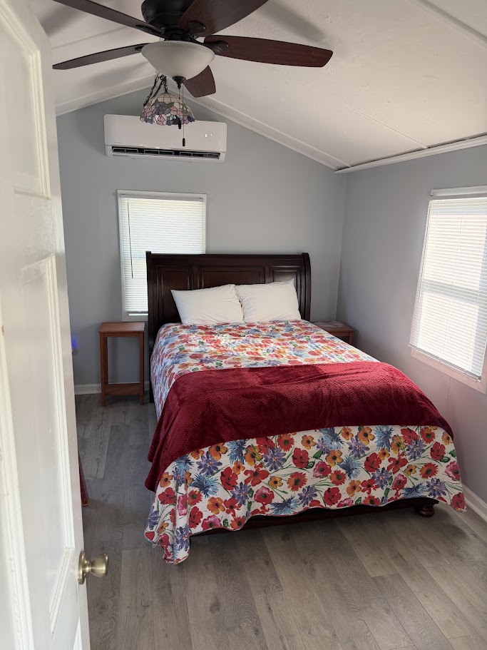 Bedroom with queen bed and dark wood headboard