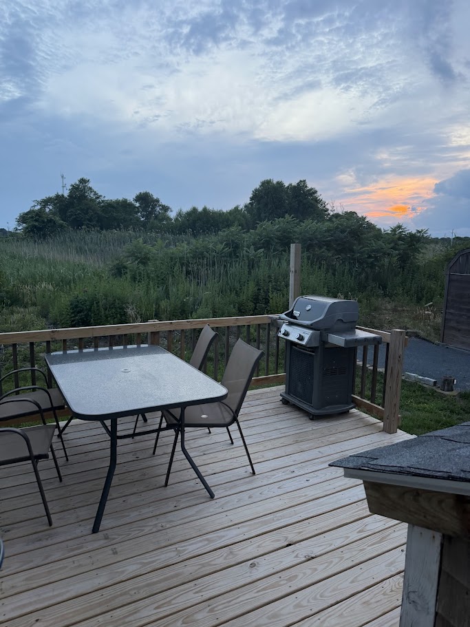 Back deck at sunset with grill and dining table